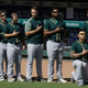 Oakland Athletics catcher Bruce Maxwell takes a knee during the national anthem before a baseball game against the Texas Rangers in Arlington, Texas, on Oct. 1, 2017. (L.M. Otero/AP Images)